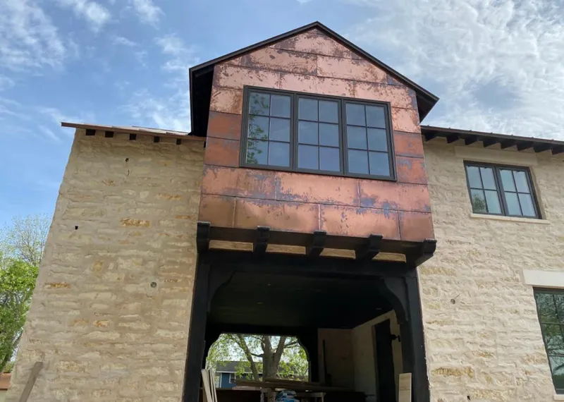 Copper metal panel facade on a stone building for Roof Repair in Sunrise