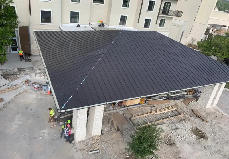 Metal roofing installation team working on a commercial building in Sunrise