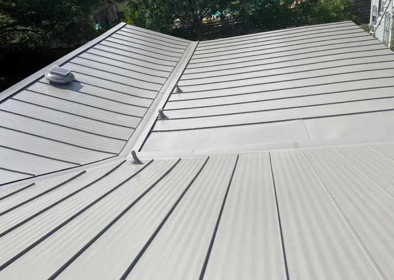Solar attic fan installed on a metal roof for Roof Ventilation in Sunrise